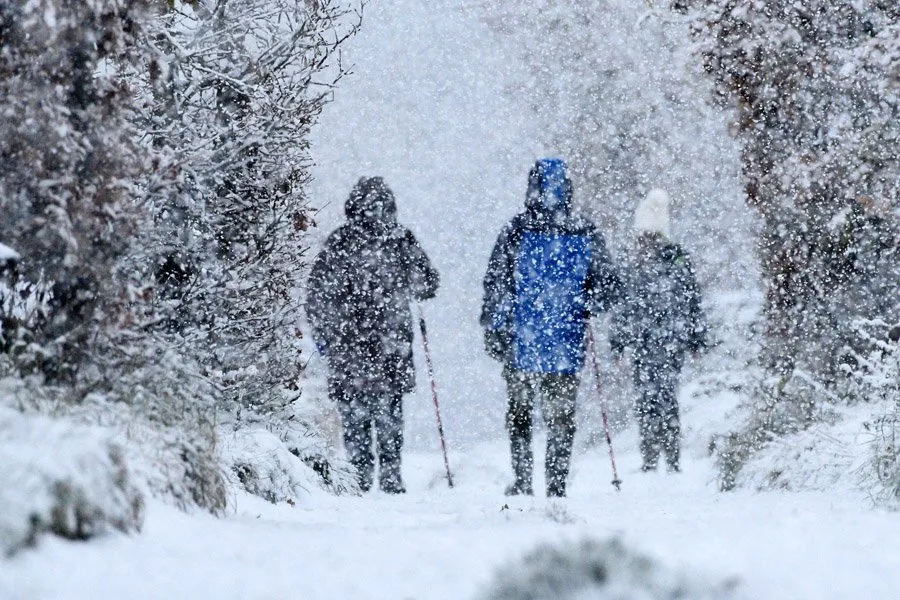 Walkers out in the snow in Honley, Holmfirth.